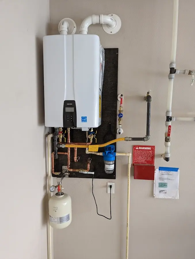 Professional plumber installing copper piping in a Bozeman home